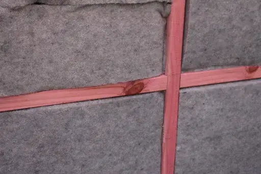 Taped vapour-permeable building wrap over insulated wall framing